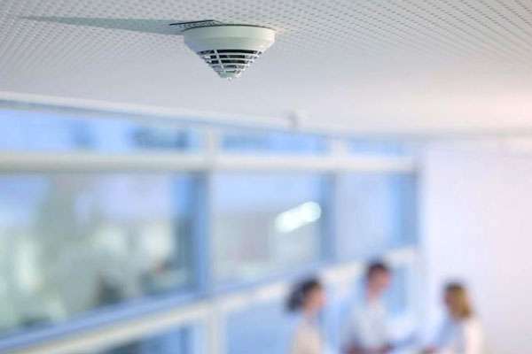 Bosch fire alarm detector installed in the ceiling of an office